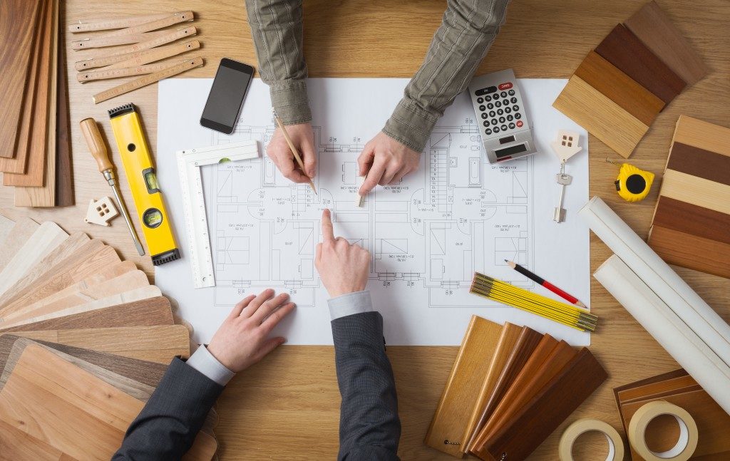 men creating a blueprint