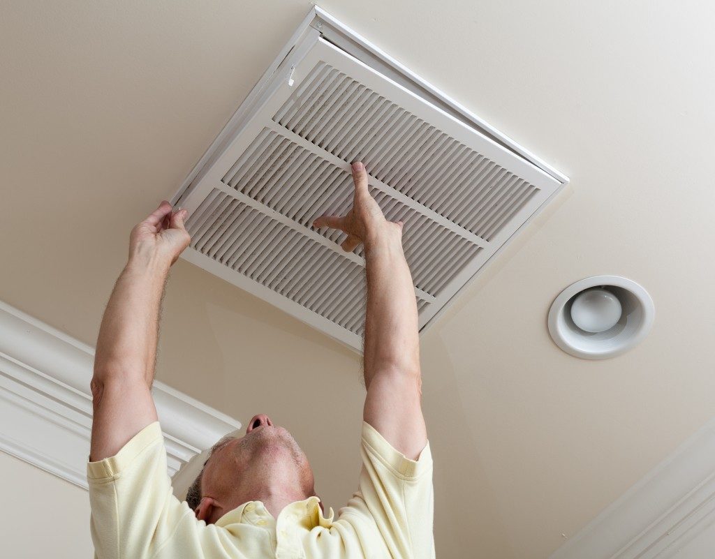 man installing an air filter