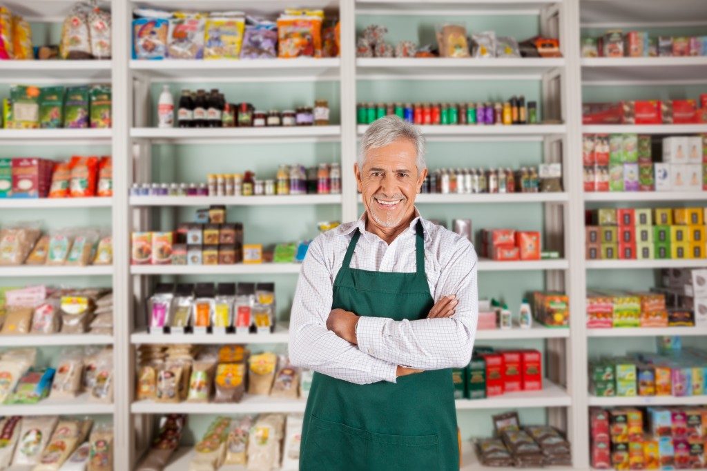 portrait of a man inside his supermarket