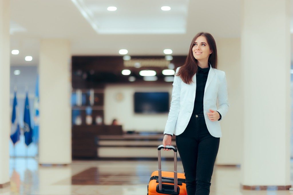 woman with luggage inside the hotel