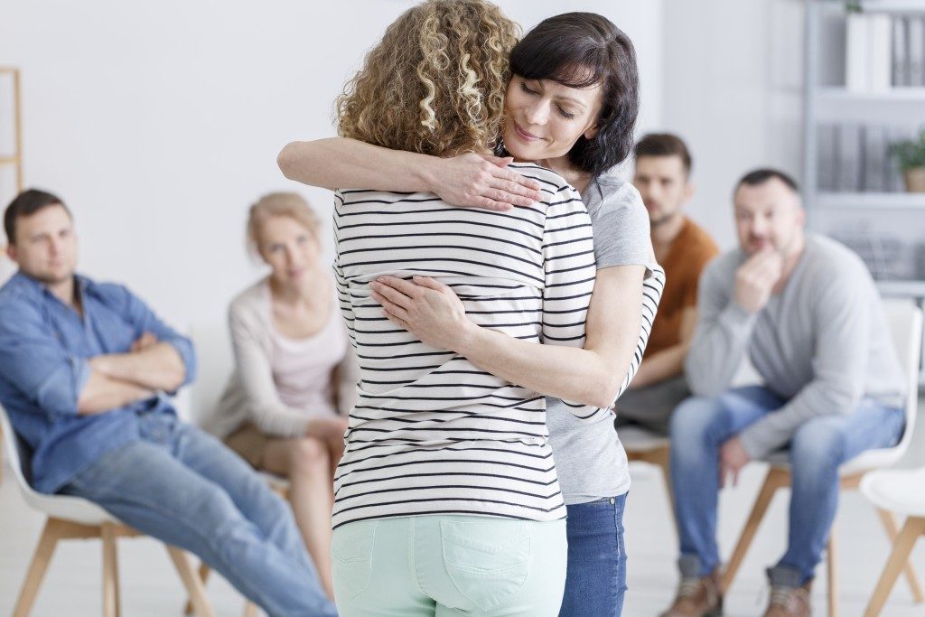people hugging each other within their support group