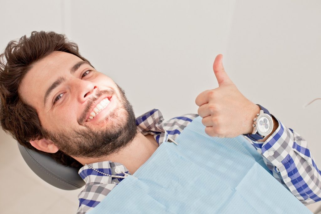 man smiling at dental clinic