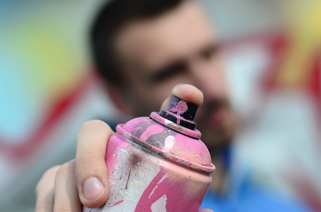 man holding spray paint can