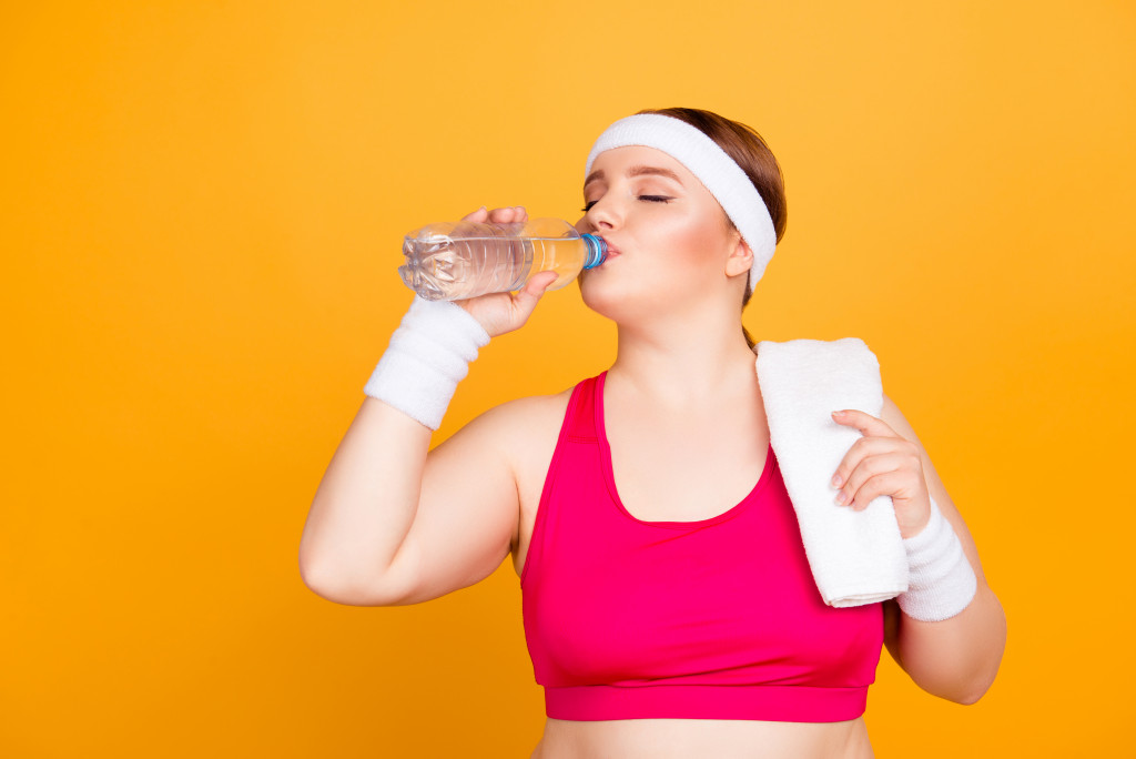 woman drinking after workout